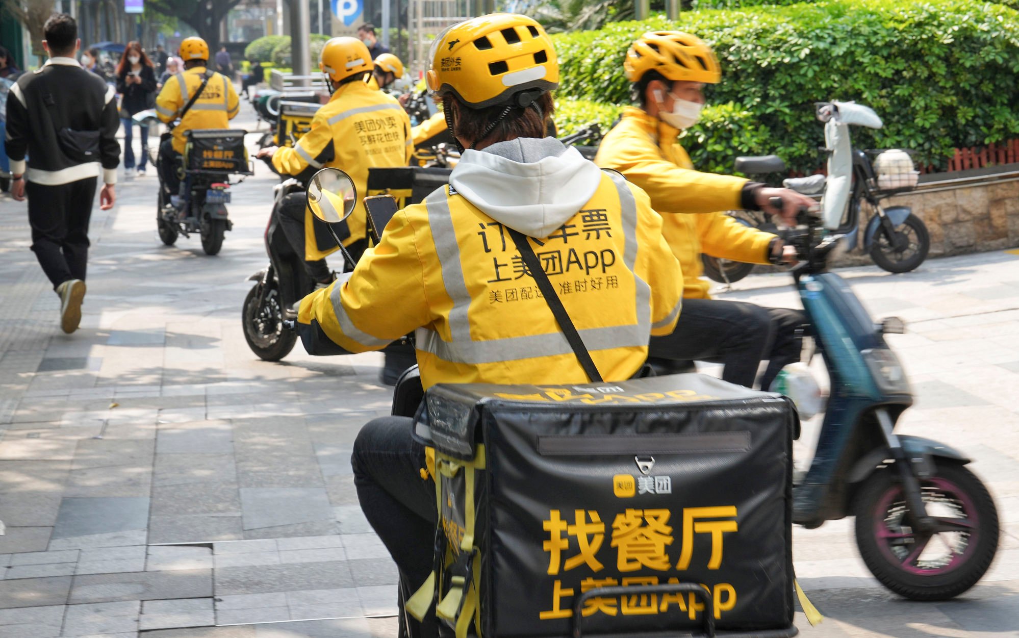 Several Meituan riders are seen on their way to deliver takeaway food to various customers at a busy street in Guangzhou, capital of southern Guangdong province, on February 23, 2023. Photo: Elson Li
